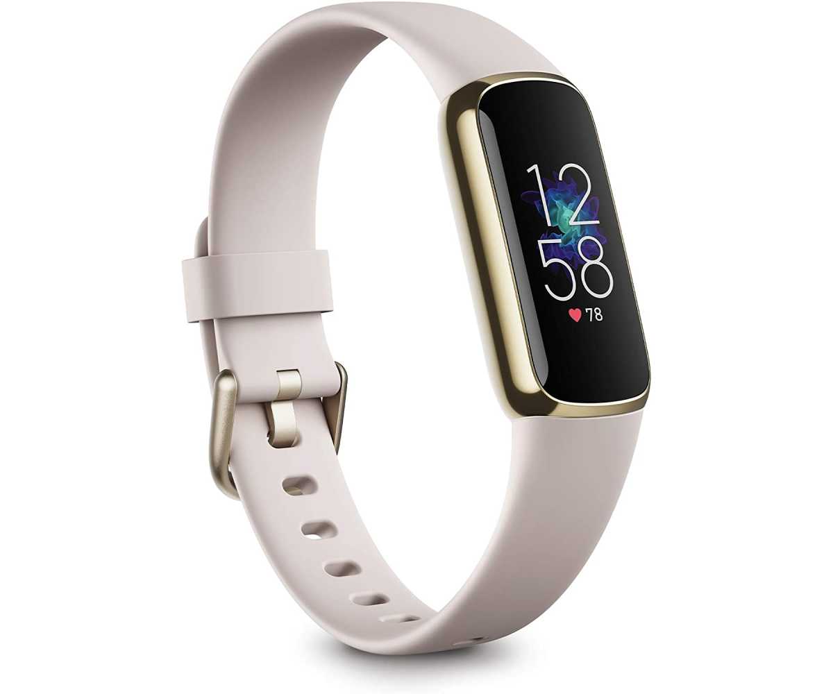 Fitbit Luxe with gold metal accent and white silicone band
