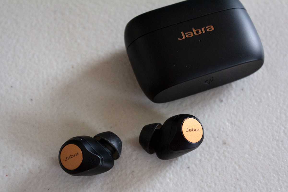 Jabra 85t outside of its case, with case behind it