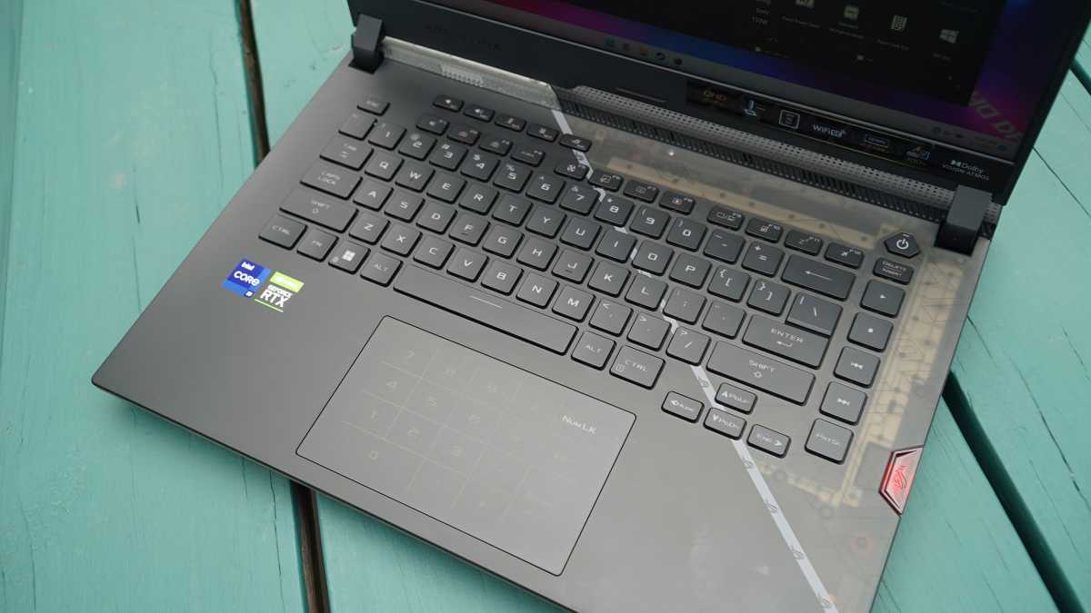 Asus Strix Scar 15 laptop keyboard and trackpad on green wood