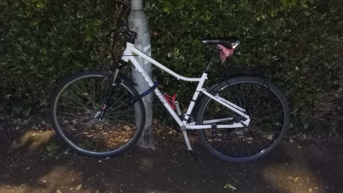 A bike locked to a lamp post 