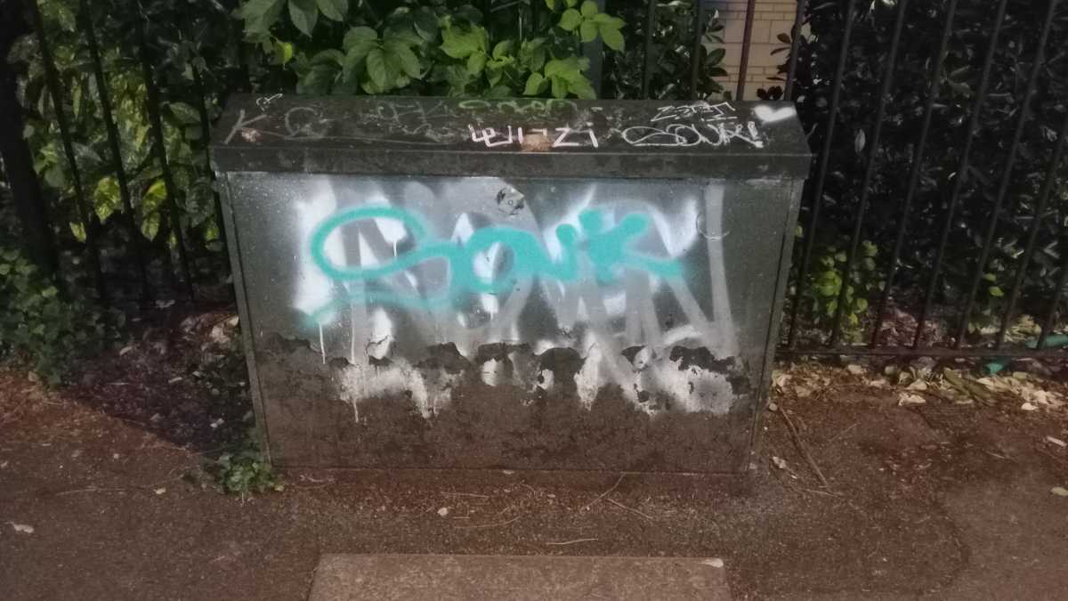 A graffitied street cabinet