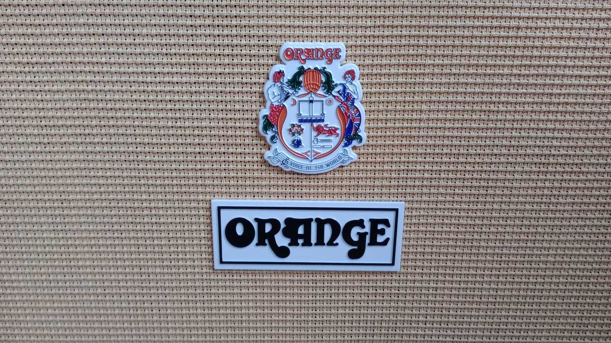 The badge on a guitar amp that says 'Orange'