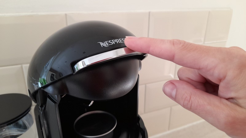 Nespresso Vertuo Plus review - latest science and technology news 2021 - Technology - Public News Time A hand touching the automatic lever on the Vertuo PLus