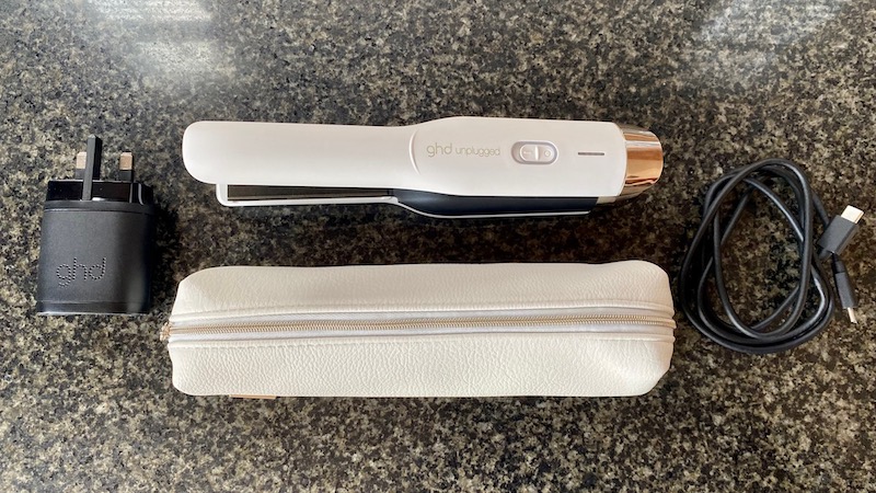 White GHD Unplugged straightener, white travel case, plug and cable