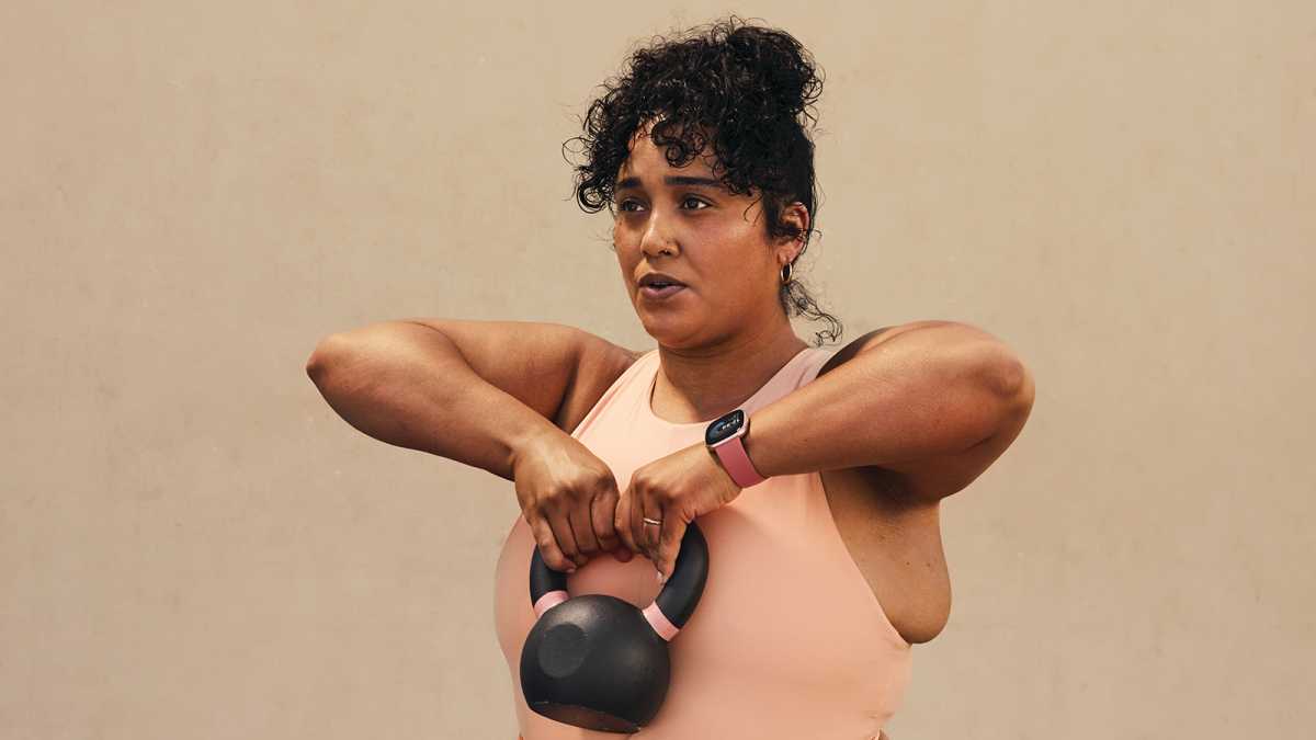 Woman exercising with a Fitbit Versa 4