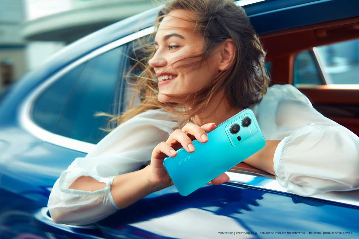 A woman holding a V25 Pro out of a car window
