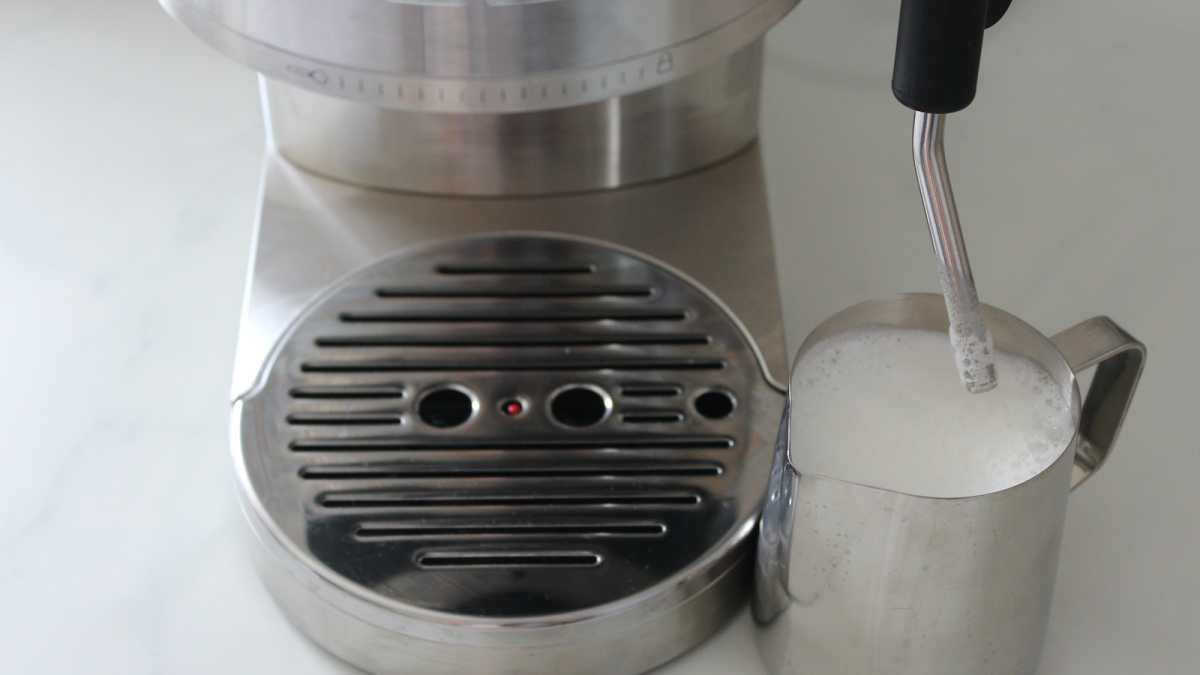 Milk wand on the KitchenAid espresso maker frothing milk