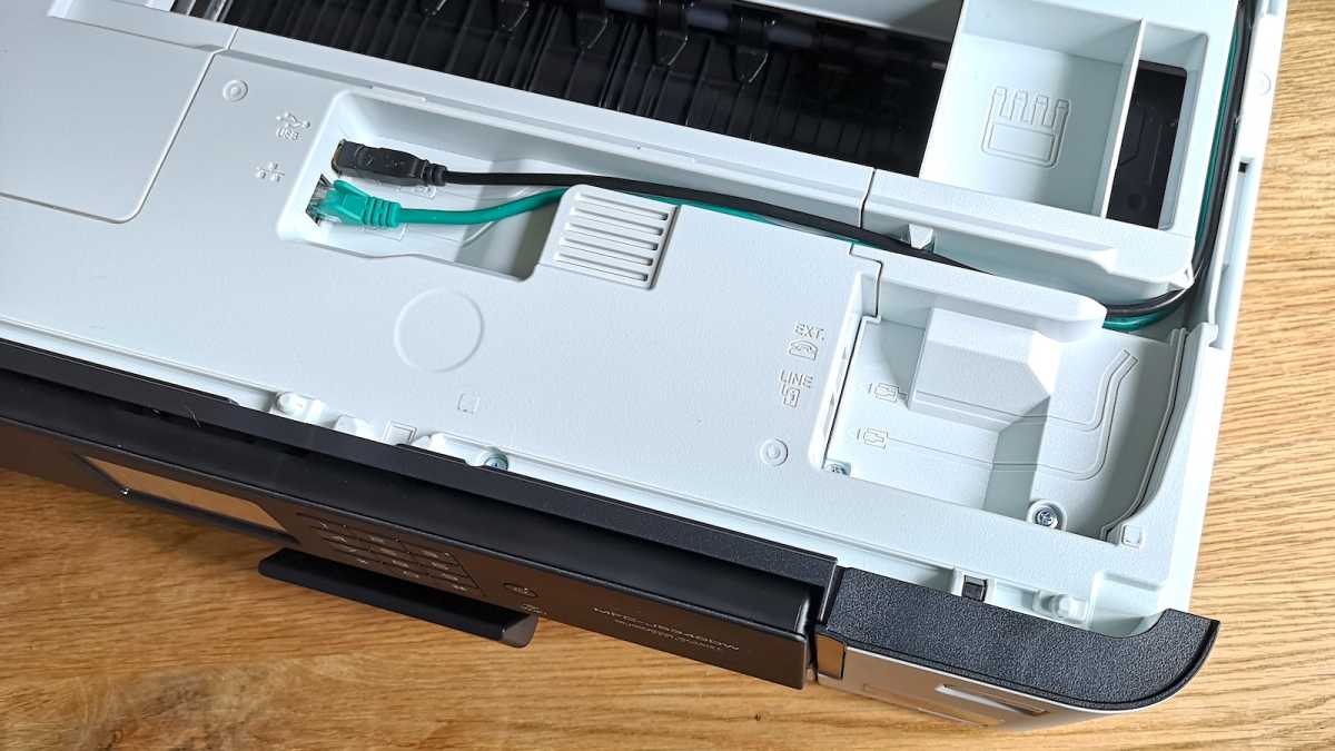 The scanner bed of the Brother MFC-J5340DW inkjet printer opened, revealing the Ethernet, Type-B USB, and fax modem ports