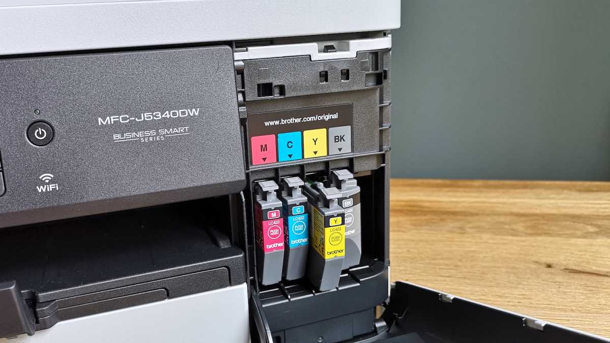Four LC422 ink cartridges, magenta, cyan, yellow, and black, sitting in the Brother MFC-J5340DW inkjet printer