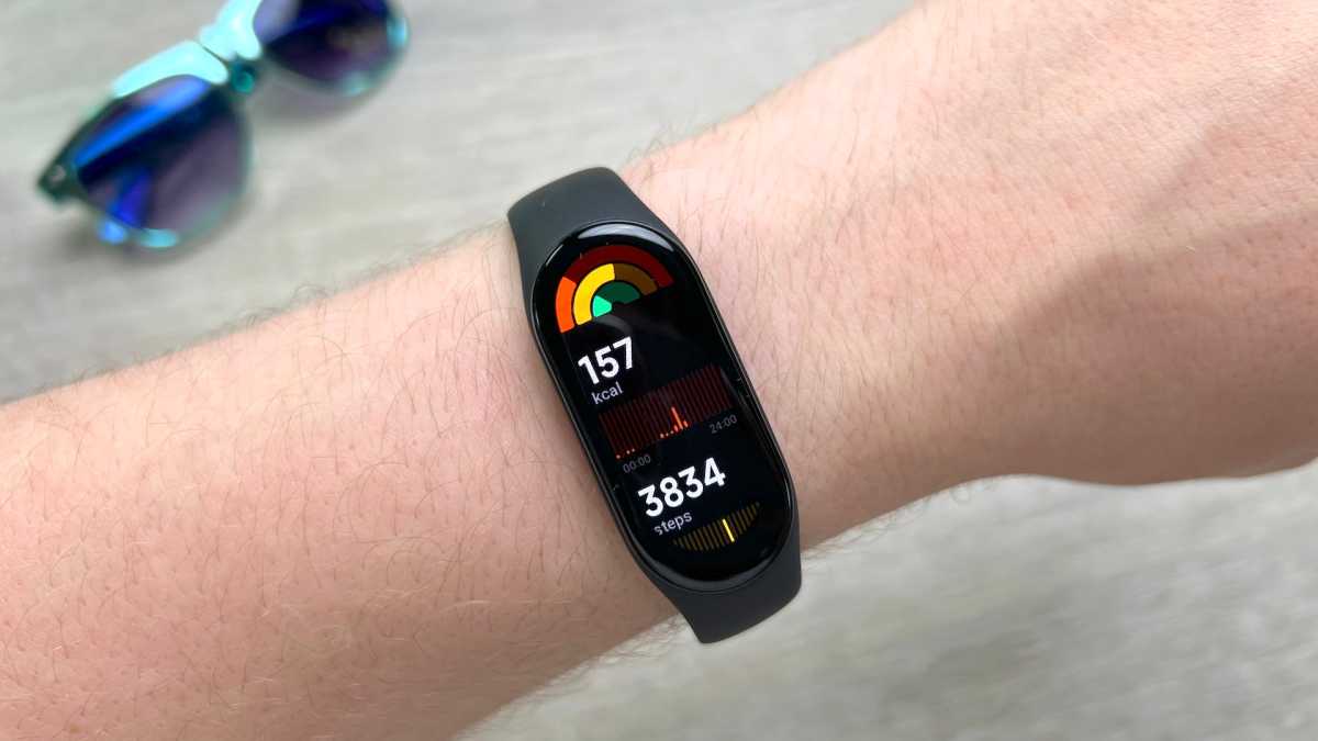 Xiaomi Mi Band 7 on the wrist displaying tracking metrics