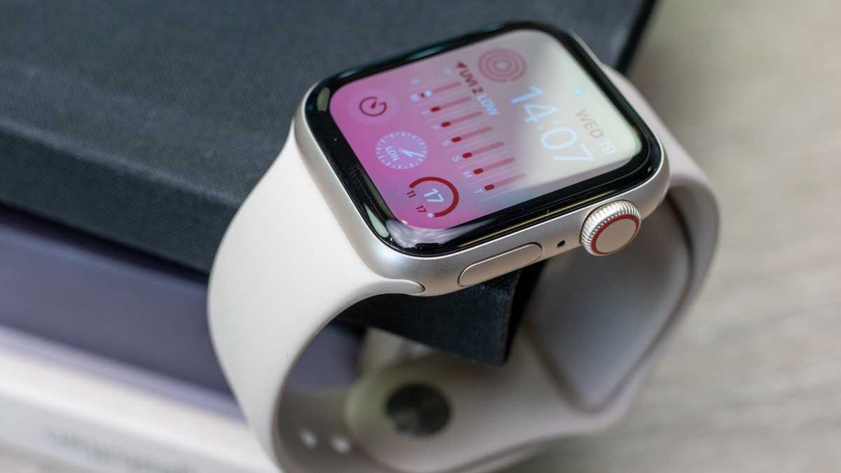 The Apple Watch SE 2022 perched on a book