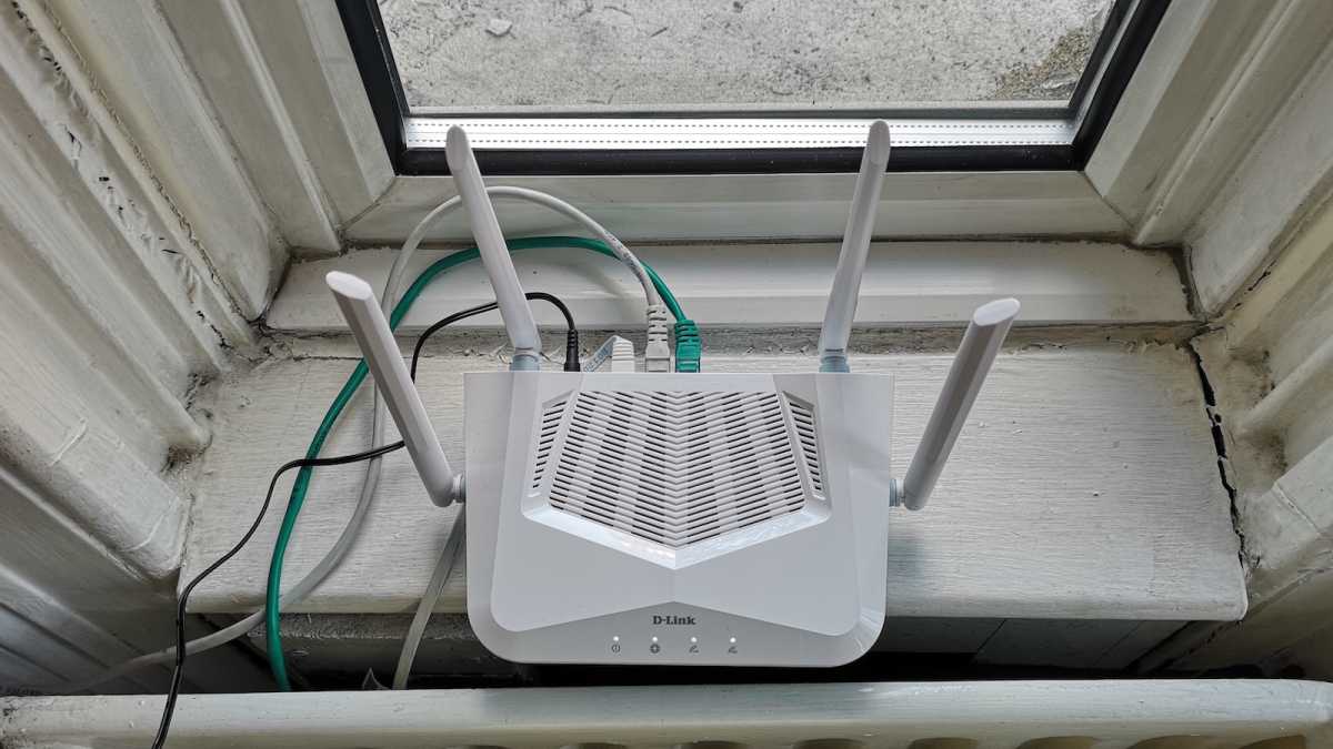 D-Link R15 router connected to the mains, with Ethernet cables attached