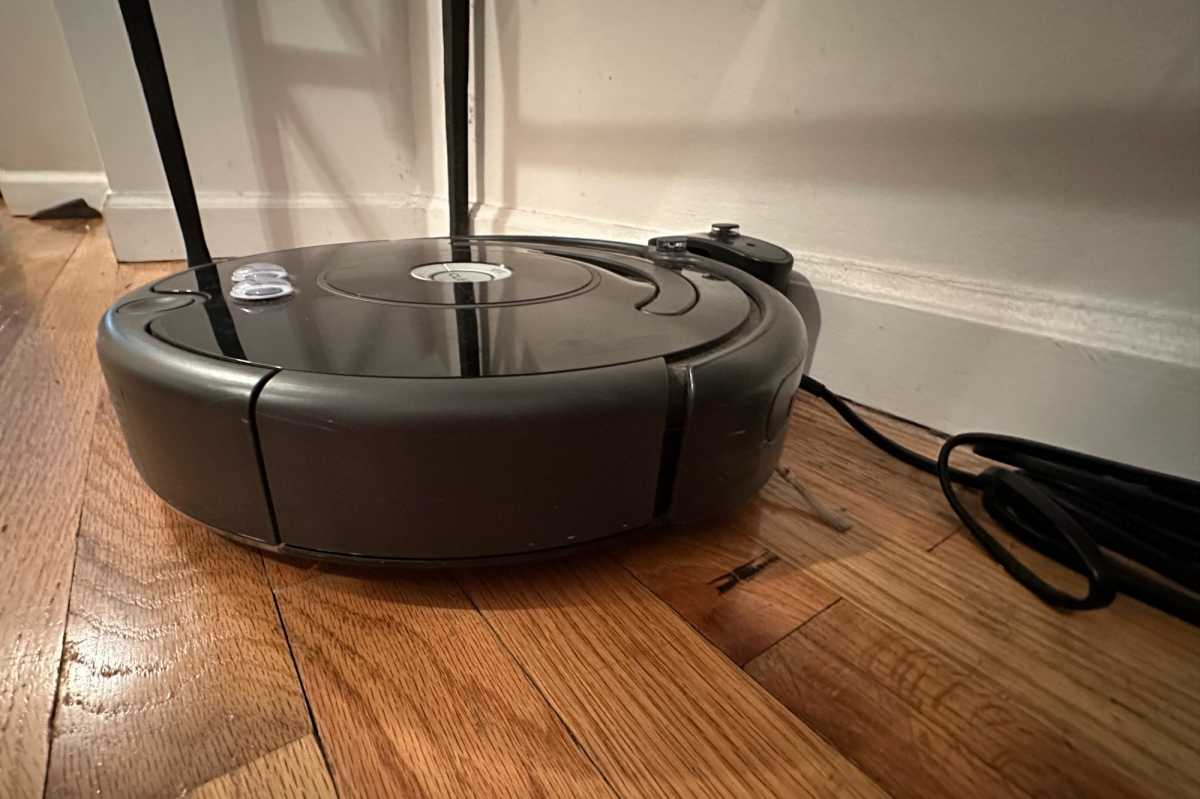 Roomba in dock next to power cord