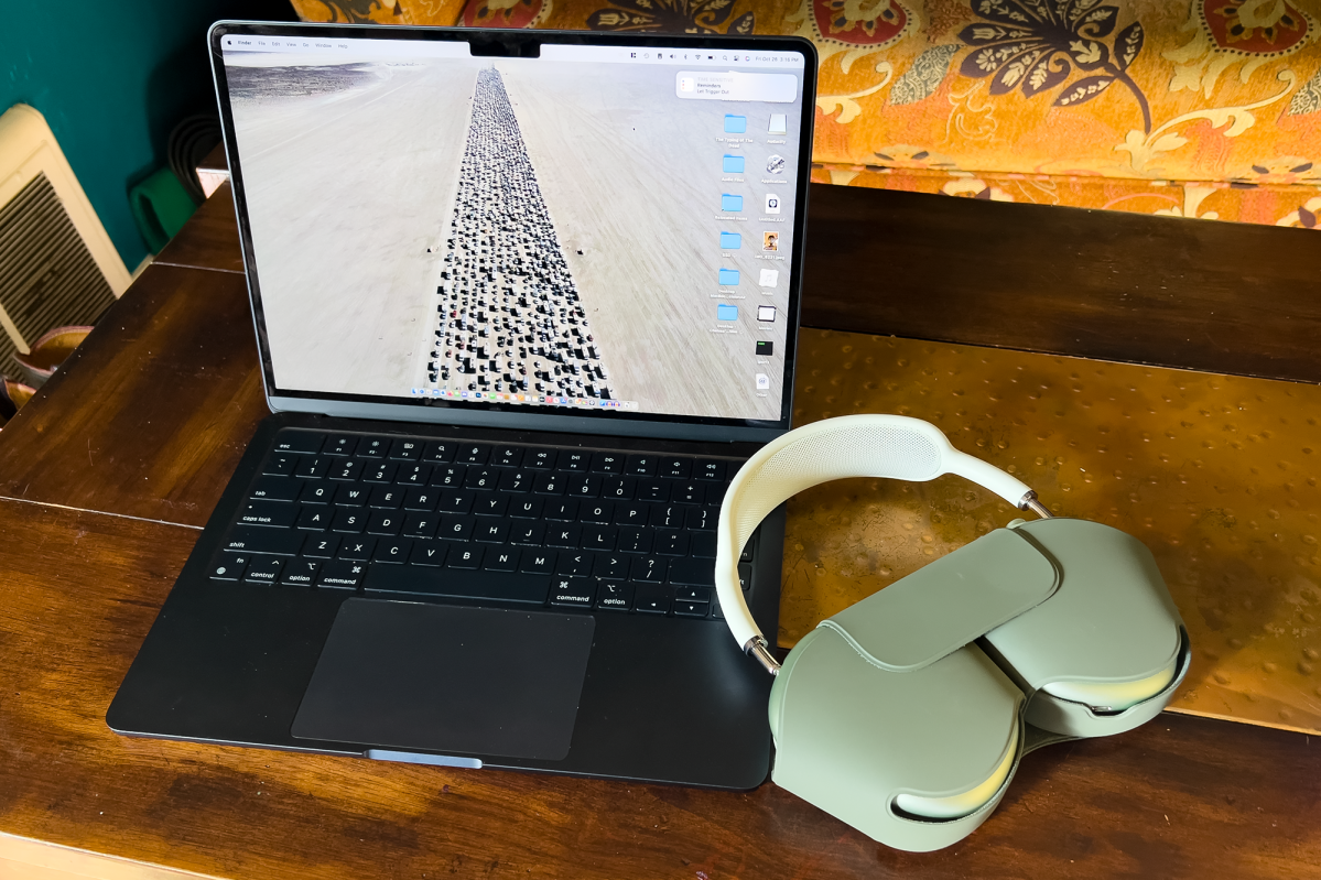 AirPods Max next to a laptop