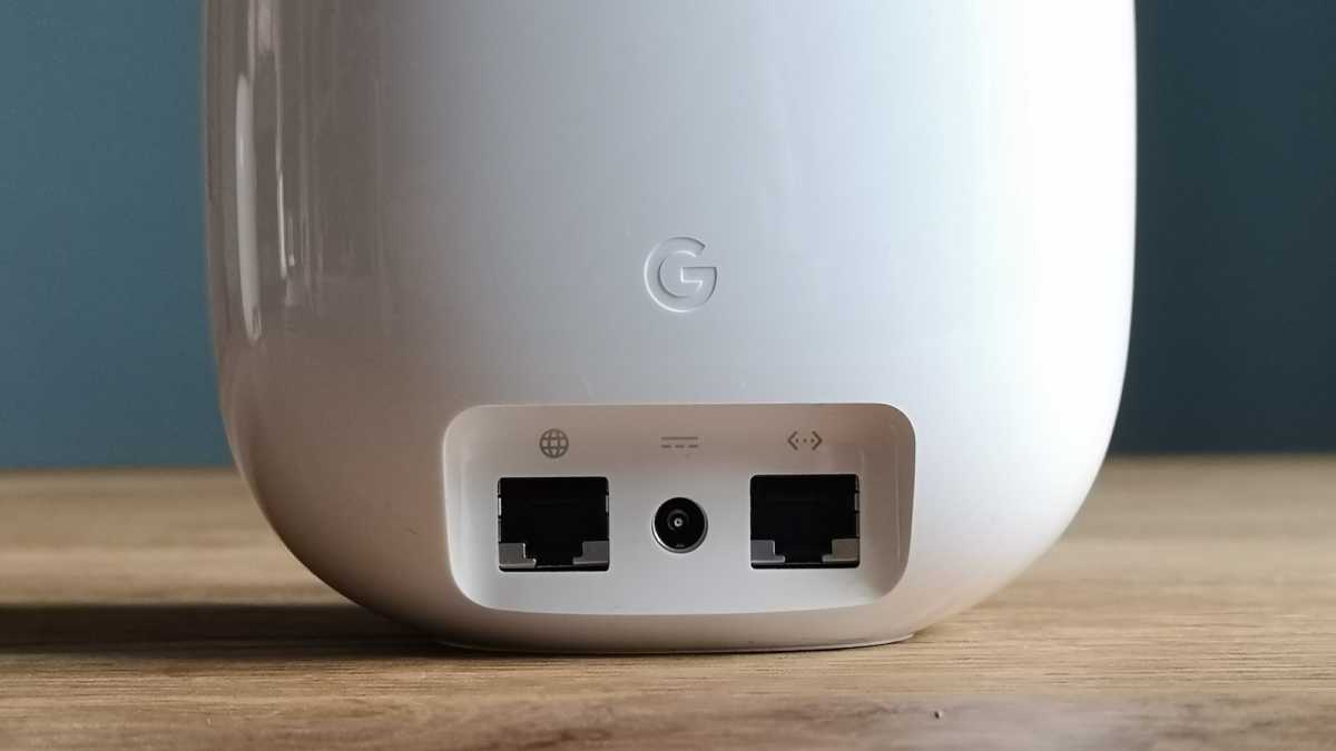 A close-up of the rear of a single Google Nest WiFi Pro device, showing off the Ethernet WAN port, mains power socket, and the Ethernet LAN port.