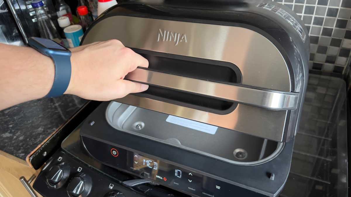 Opening the lid of the Ninja Foodi MAX Health Grill & Air Fryer