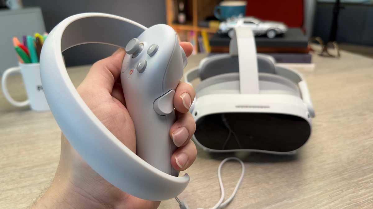 Pico 4 controller with headset in the background