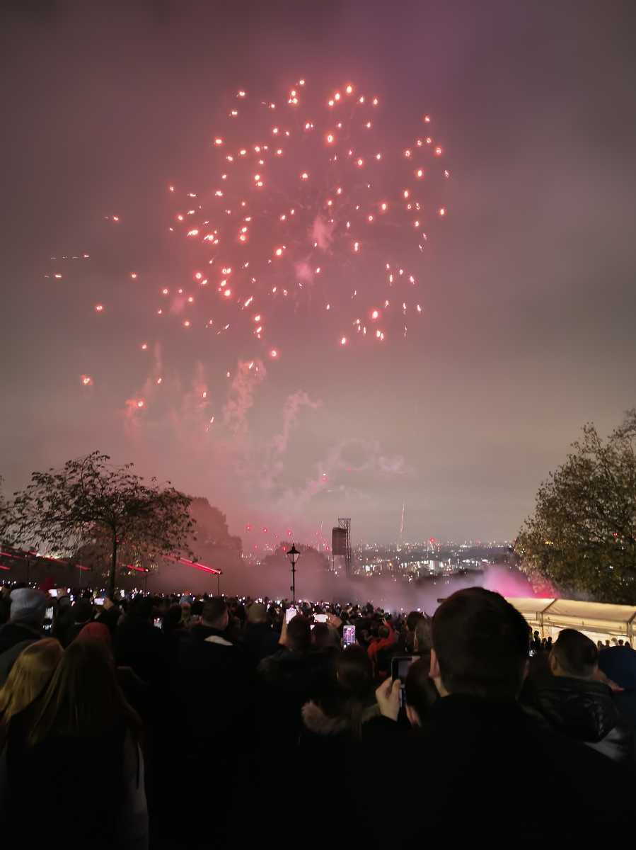 Fireworks in sky at Alexandra Palace on bonfire night with crowd watching