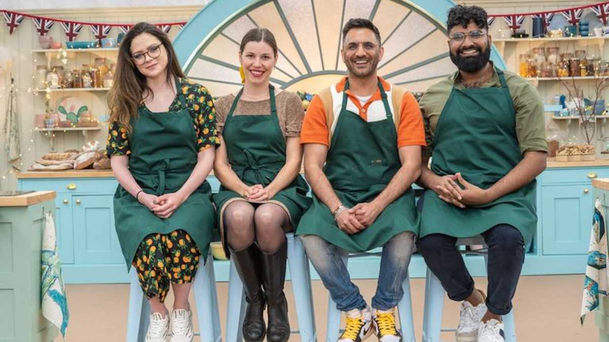 Bake Off contestants sitting on stools, smiling awkwardly