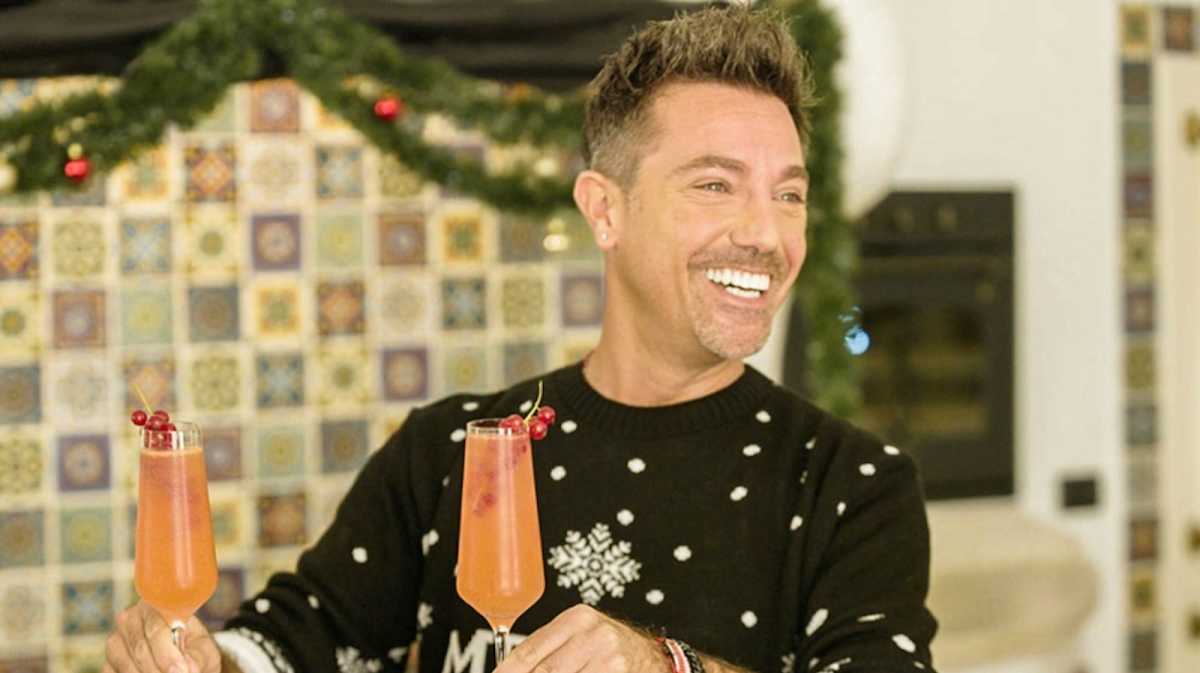 Gino D'Acampo holding two cocktails