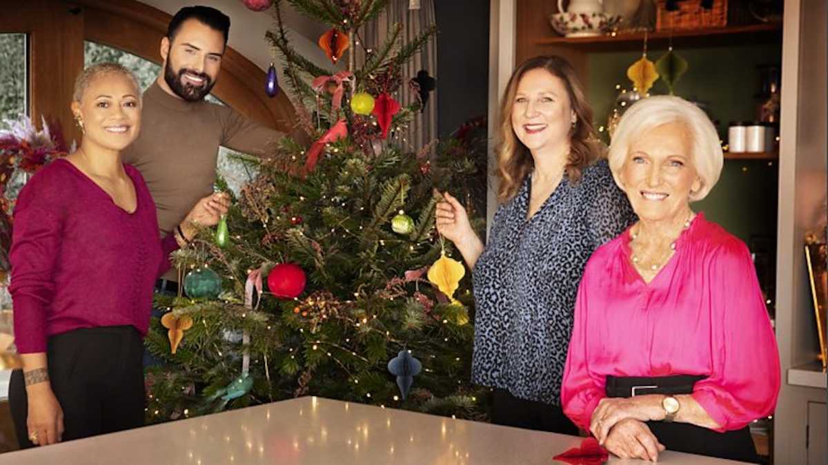 Mary Berry and her guests photographed in front of a Christmas tree