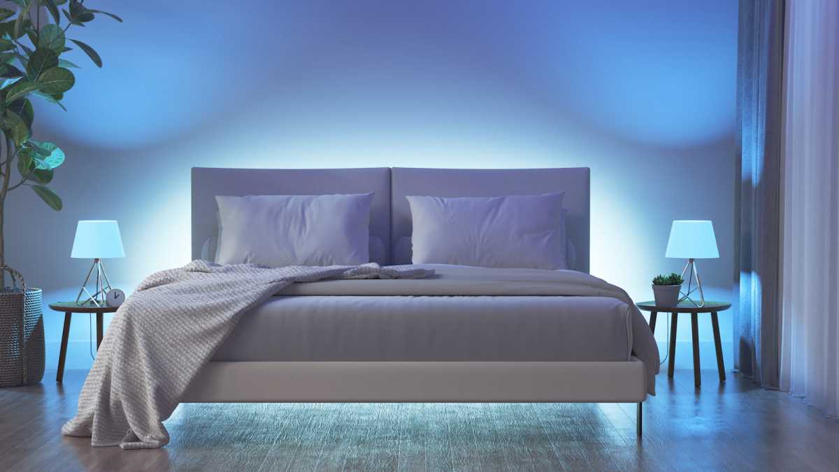 A bedroom lit by colour-changing bulbs