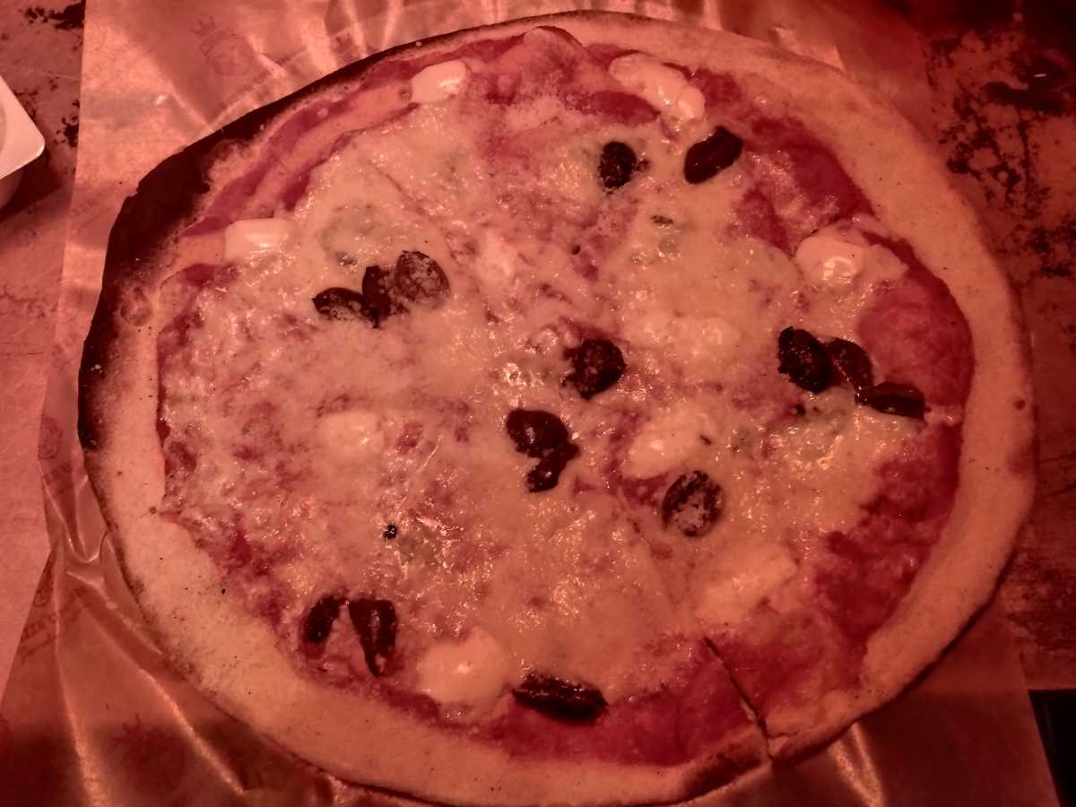 Low light shot of pizza in a restaurant