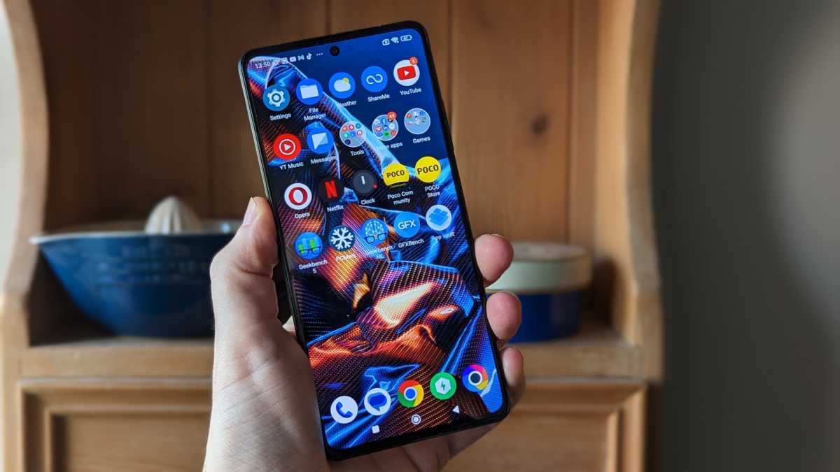 Poco X5 Pro in front of shelves