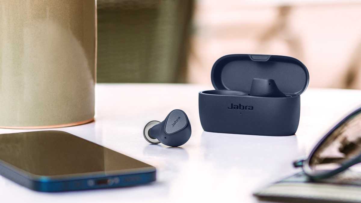 Jabra Elite 4 headphones with phone and glasses