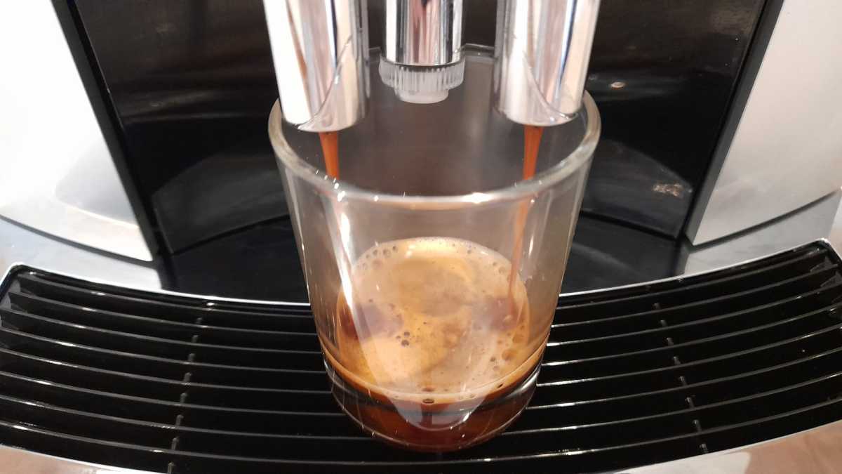 Jura E6 dispensing espresso into a cup