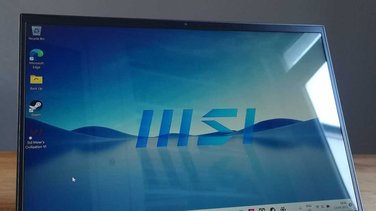 A close-up of the MSI Prestige 14 Evo (2023)'s display, with glare from a nearby window hitting the reflective cover