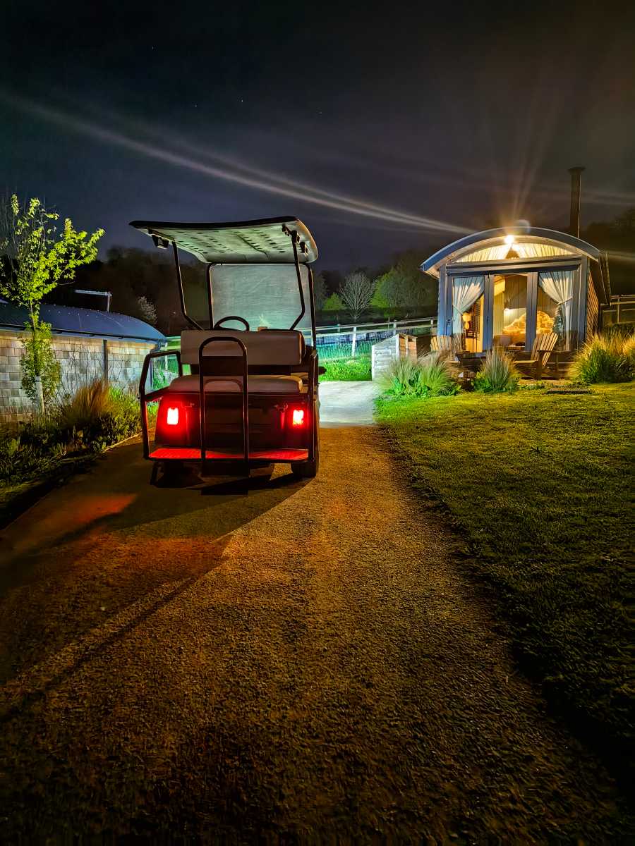 Shepherd's hut with golf buggy at night