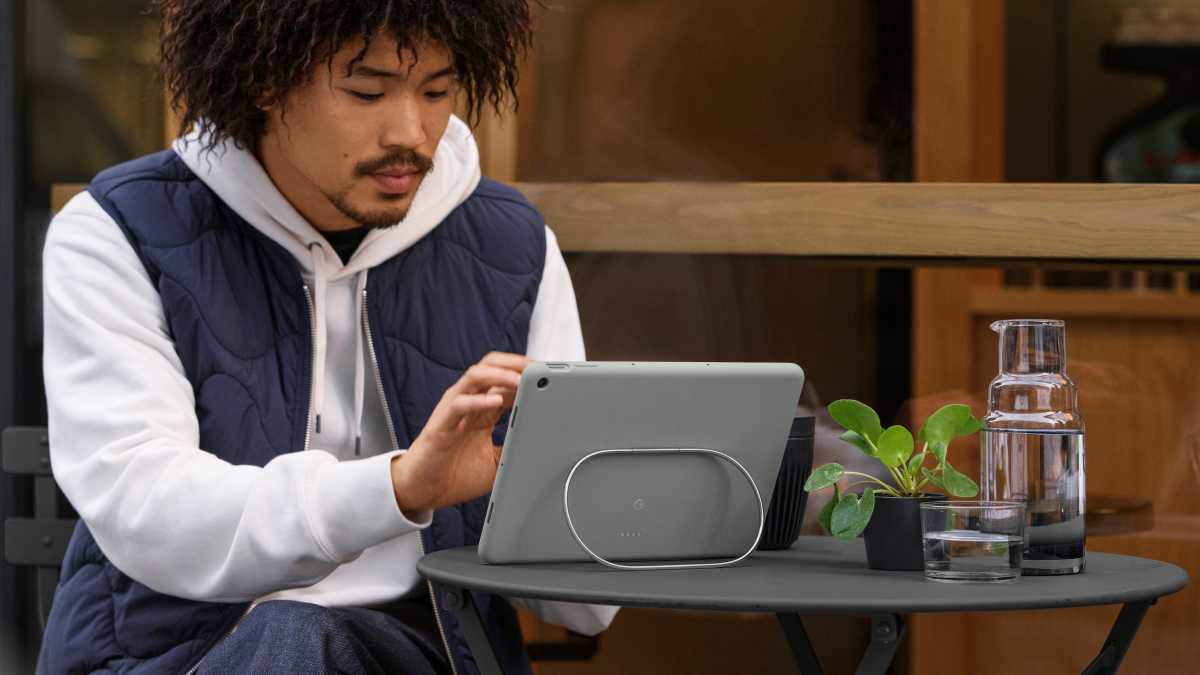 Man using Pixel Tablet with case on small table