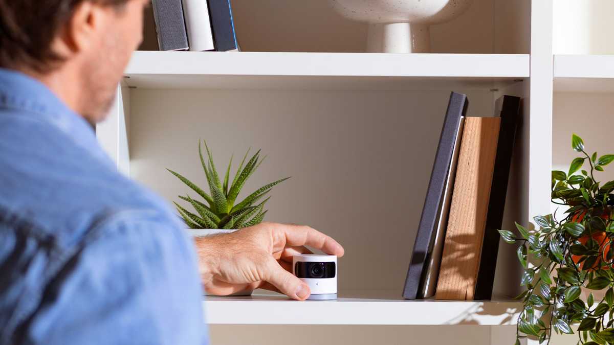 Sky Protect indoor camera being placed on a shelf