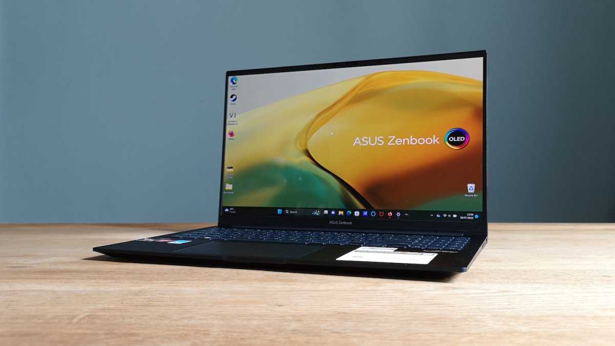 Asus Zenbook 15 OLED laptop, screen on, viewed from the front, tilted slightly to the left