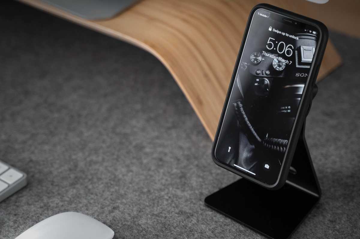 iPhone on a black phone stand