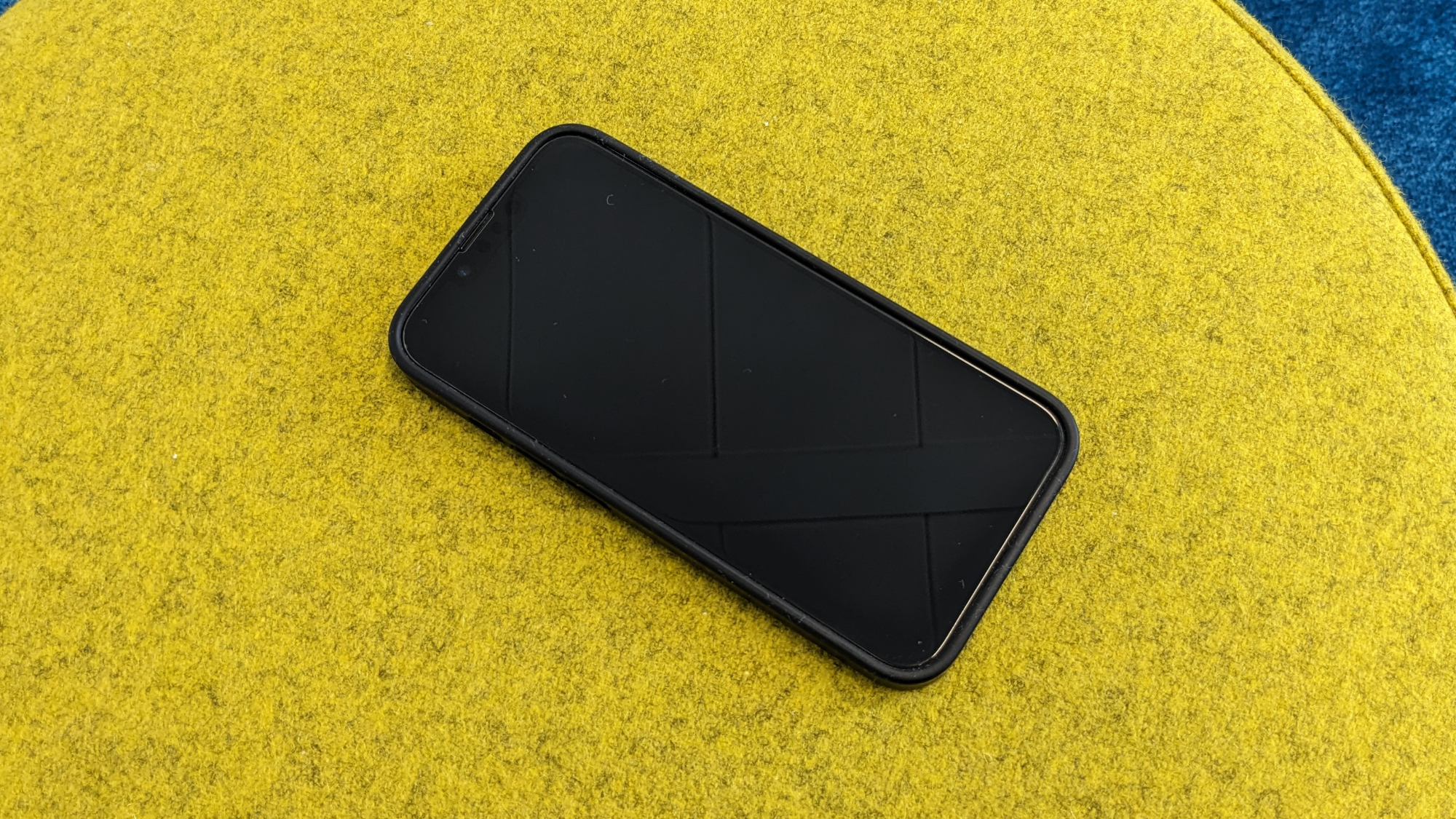 iPhone 14 in einer schwarzen Silikonhülle hone sichtbaren Alu-Rahmen