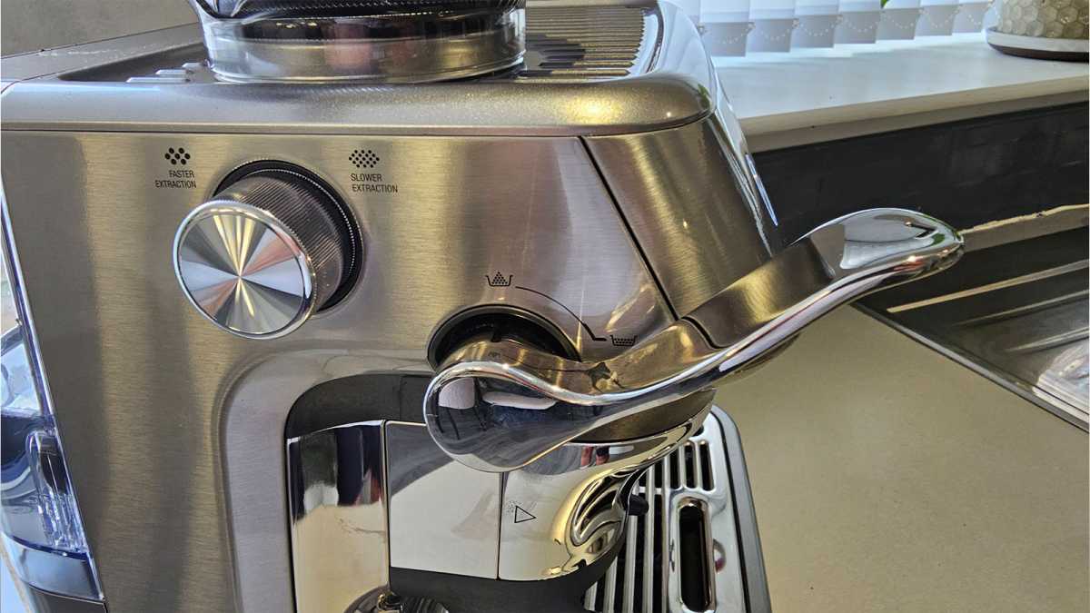 Barista Touch Impress stainless steel tamping lever on the side of the machine