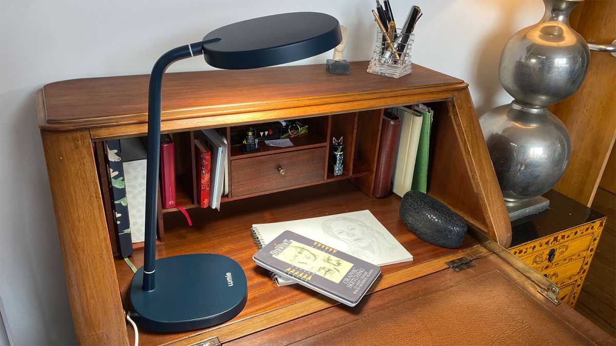 The Lumie Task in use on a desk with a sketch underneath it