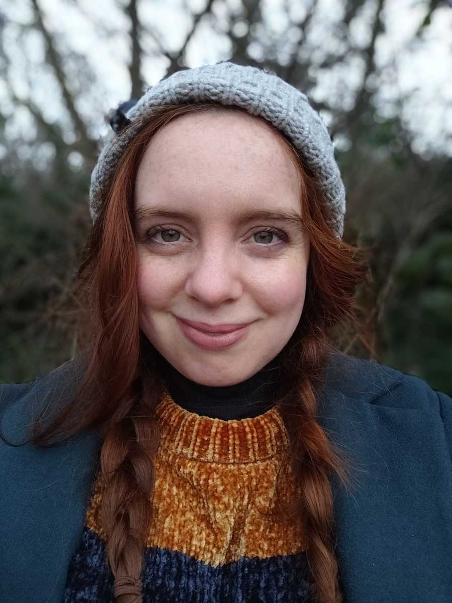 Selfie of red-haired woman in portrait mode