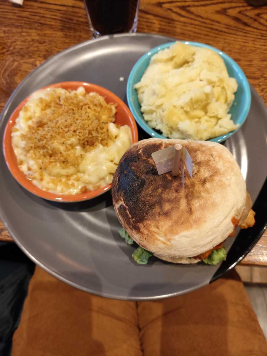 Nandos burger with sides of mash and mac and cheese