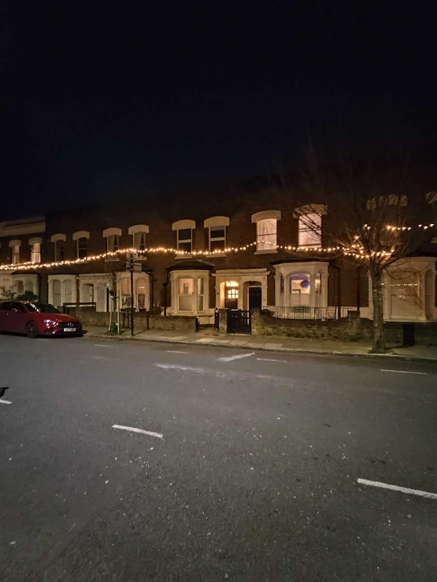 Street at night with fairy lights in wide-angle mode