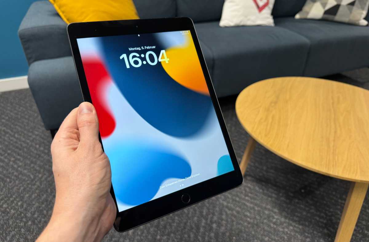 iPad 7 is held vertically in the left hand