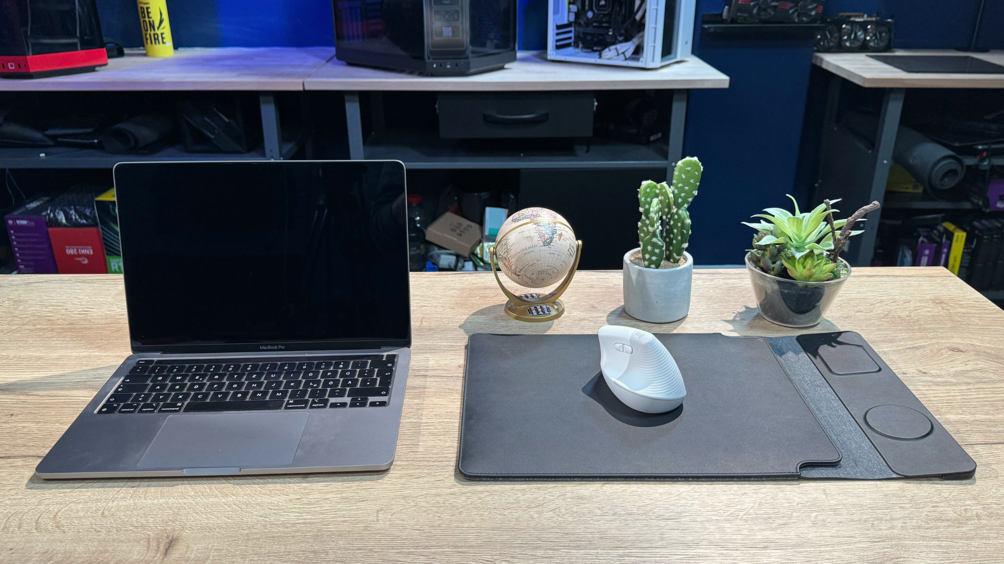 Geöffnetes Macbook Pro neben der Journey NEXA, auf der eine weiße Maus liegt