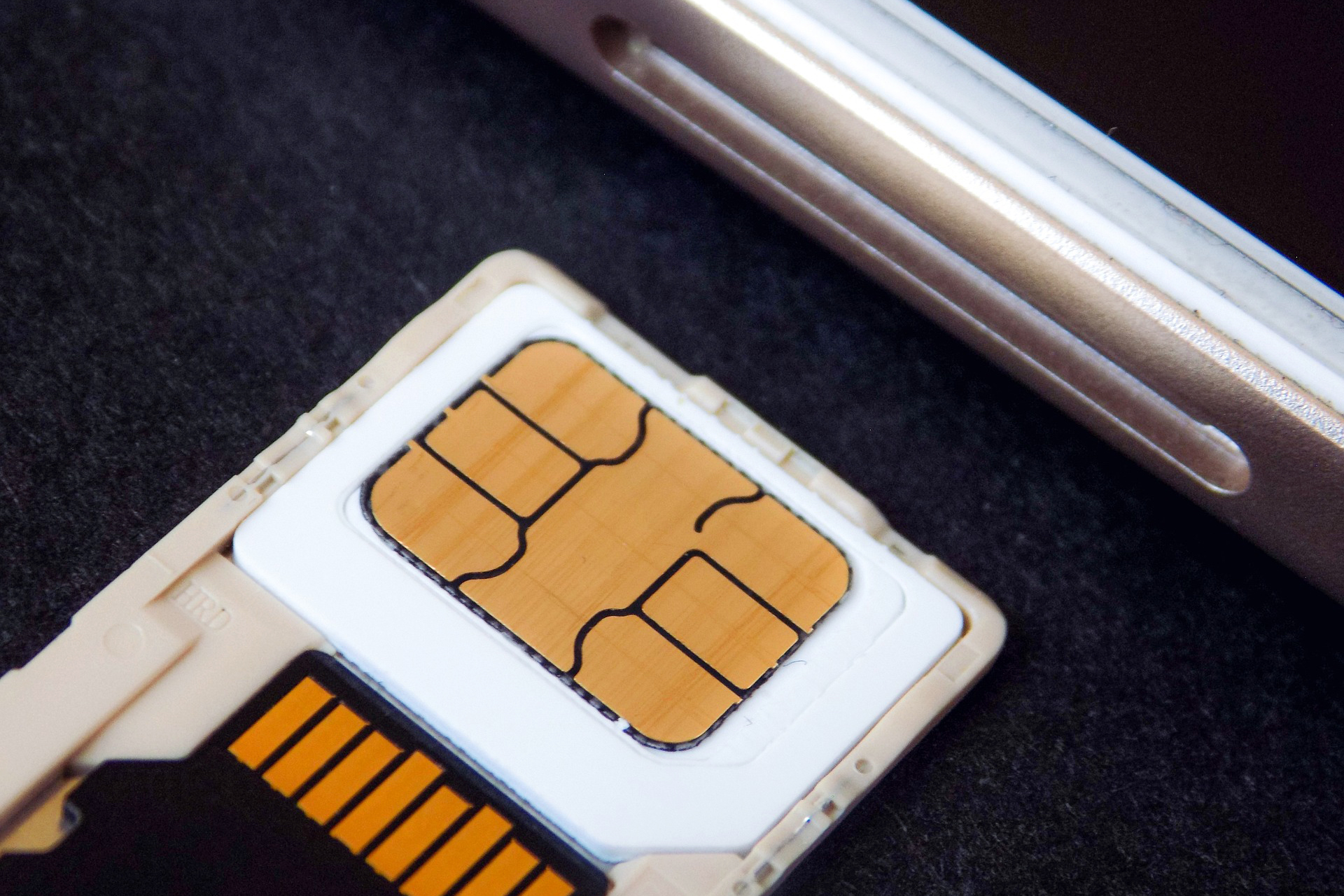 SIM card next to the SIM card slot for a mobile phone