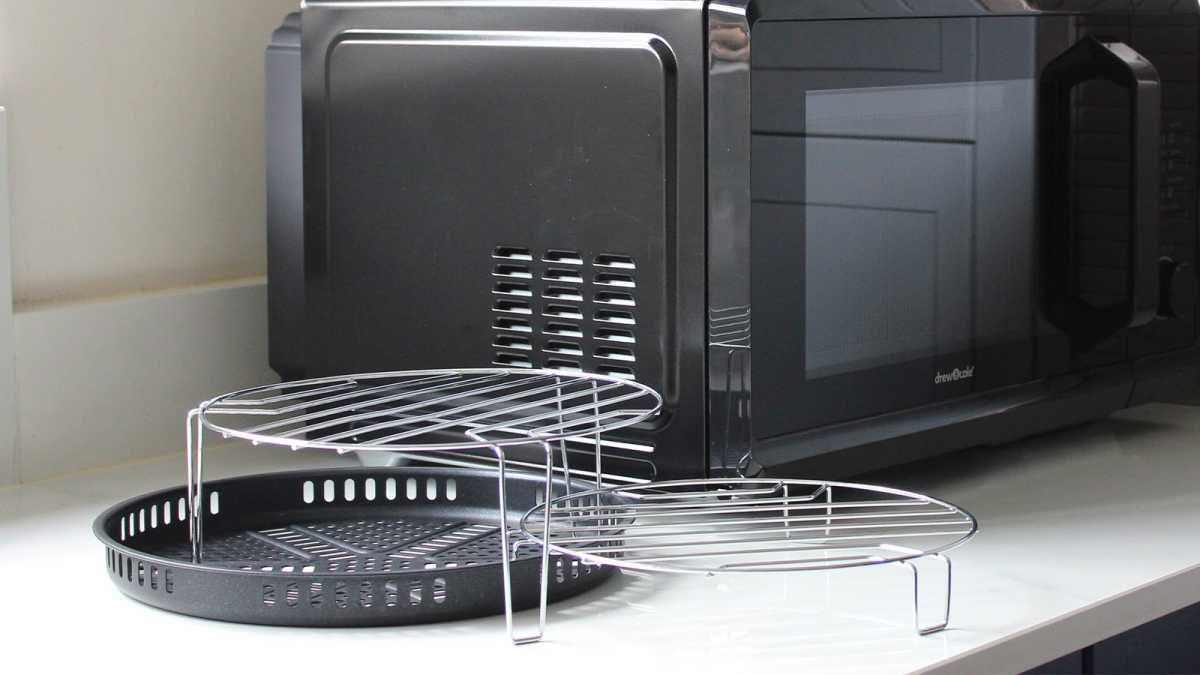 Cooking racks and trays in front of the microwave air fryer