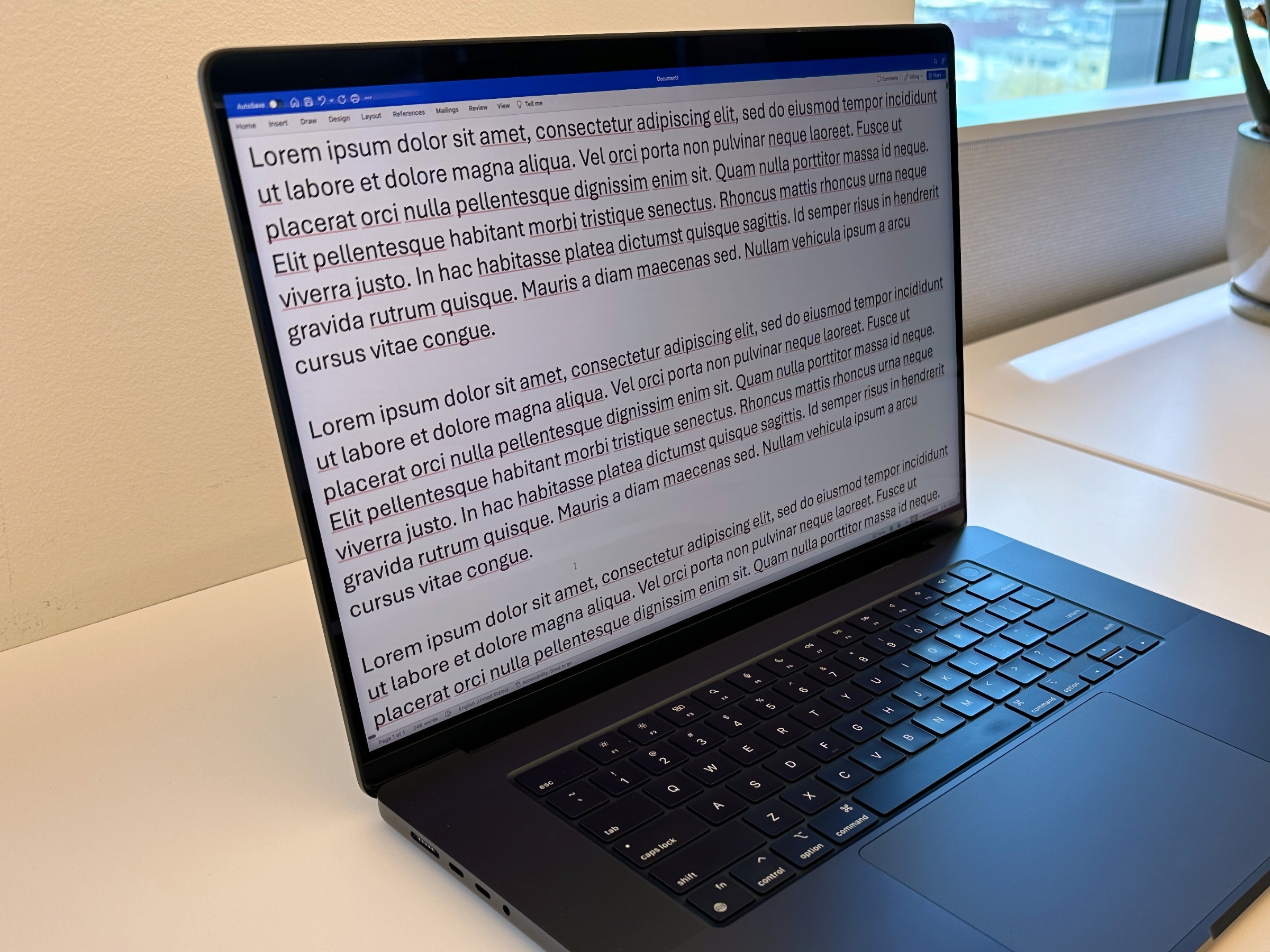 Text displayed on the left corner of the MacBook Pro