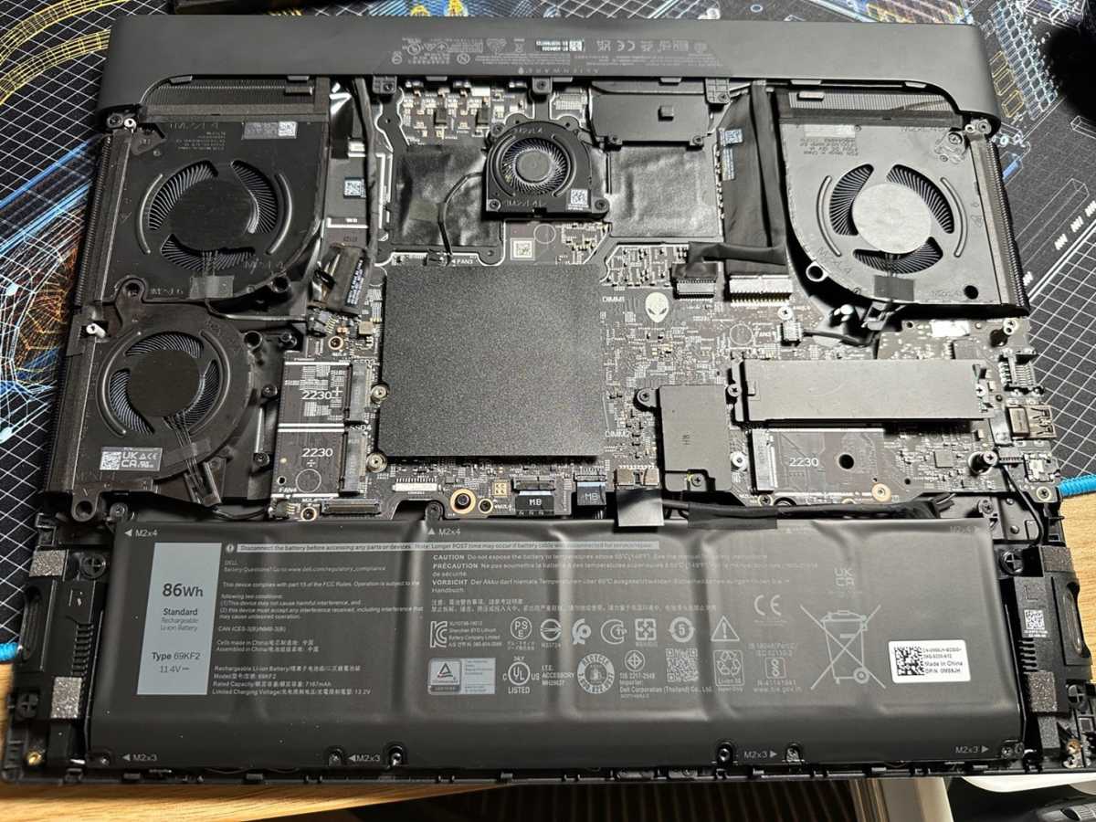 Open laptop with exposed fans and internals