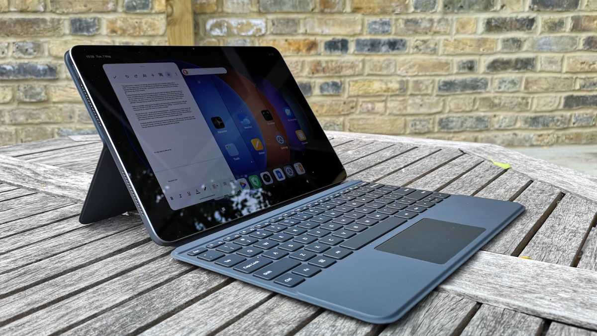Front view of the Xiaomi Pad 6S Pro in a Touchpad Keyboard case, stood up on a wooden picnic table