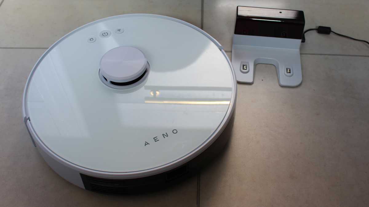 The Aeno next to its compact charging base
